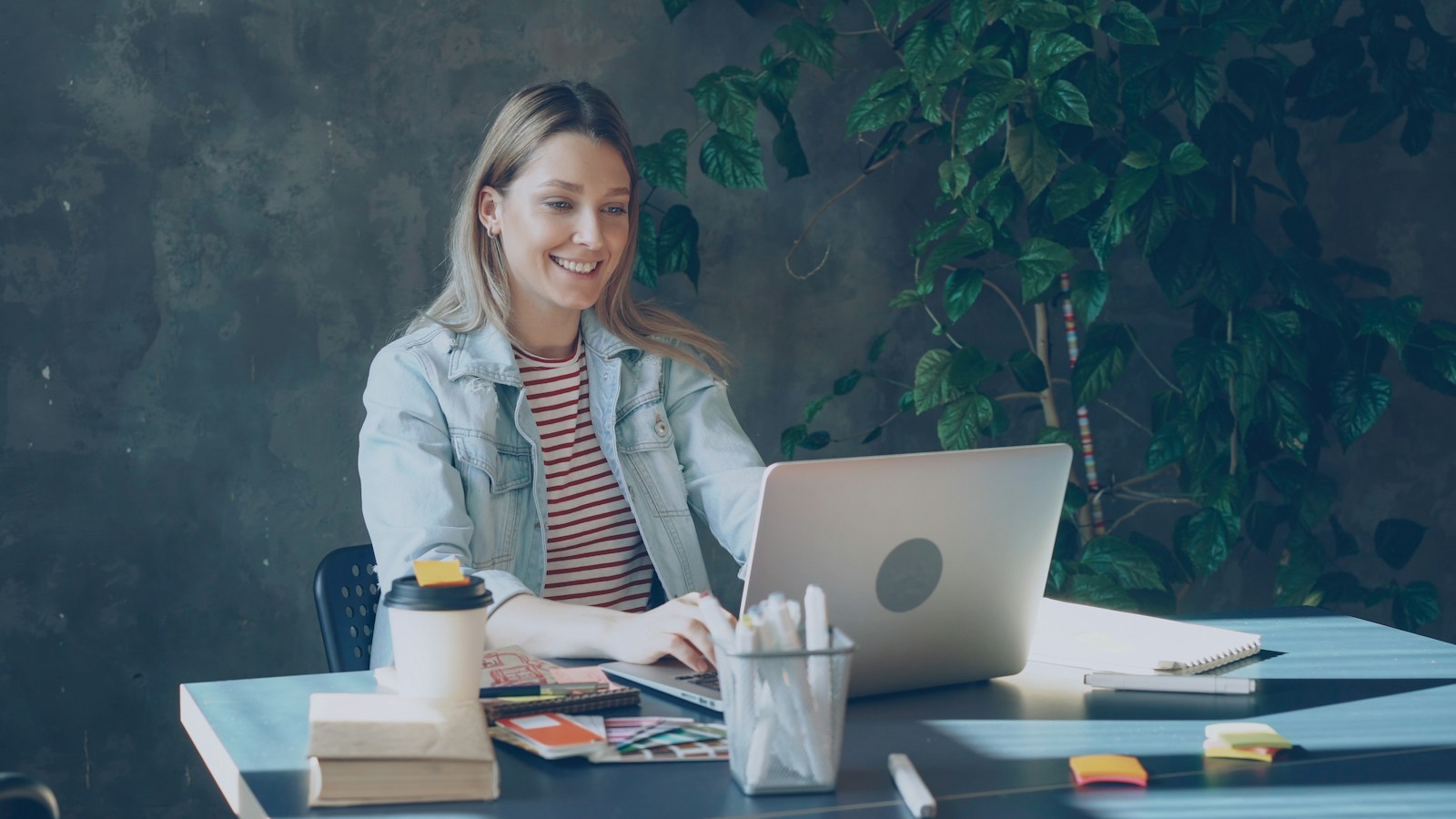 A person smiling at a laptop